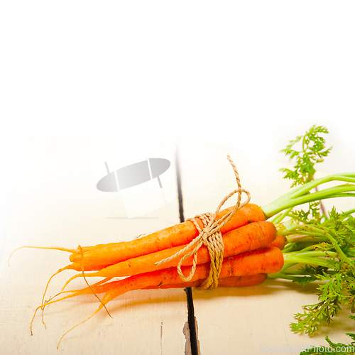 Image of baby carrots bunch tied with rope