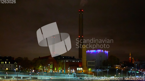 Image of Modern grain terminal at night. Metal tanks of elevator. Grain-drying complex construction. Commercial grain or seed silos at seaport. Steel storage for agricultural harvest