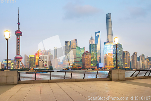 Image of Illuminated Shanghai skyline from embankment