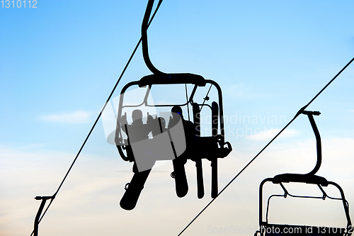 Image of people on chairlift with skis