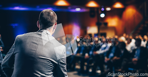 Image of Public speaker giving talk at Business Event.