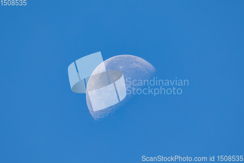 Image of moon in the day time on blue sky