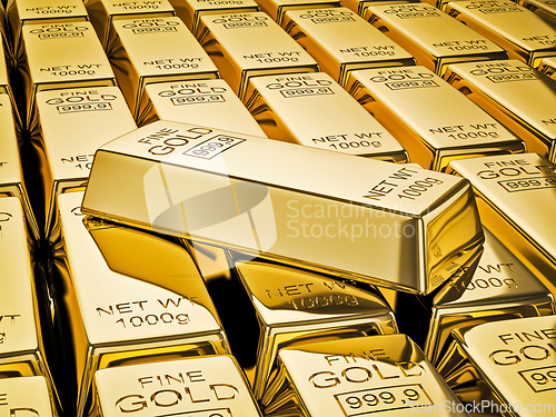 Image of Gold bar on stacks of gold bullions close up