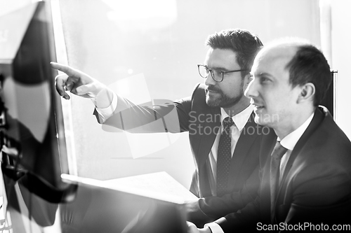 Image of Business team analyzing data at business meeting in modern corporate office.