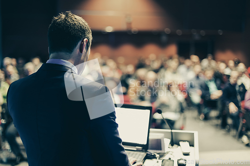 Image of Speaker at Business Conference and Presentation.