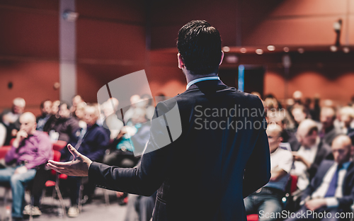 Image of Speaker giving a talk at business conference meeting.