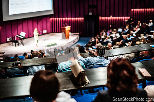 Image of Woman giving presentation on business conference event.