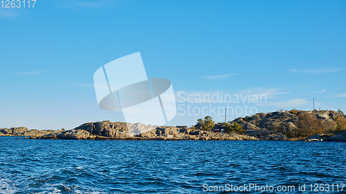 Image of Red house at sea shore in the baltic sea in dull colors in autumn.