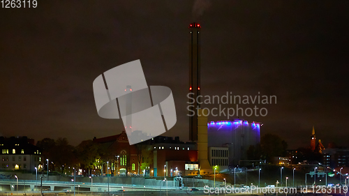 Image of Modern grain terminal at night. Metal tanks of elevator. Grain-drying complex construction. Commercial grain or seed silos at seaport. Steel storage for agricultural harvest