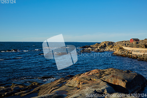 Image of Red house at sea shore in the baltic sea in dull colors in autumn.