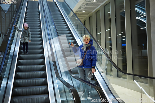 Image of Mother and child together on escalator background. Terminal, air