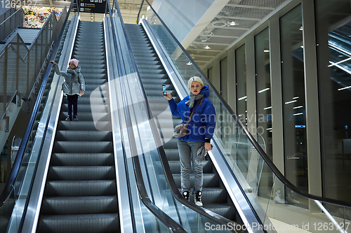 Image of Mother and child together on escalator background. Terminal, air