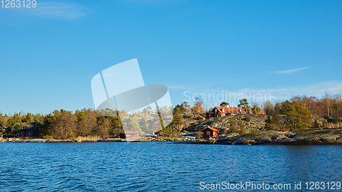 Image of Red house at sea shore in the baltic sea in dull colors in autumn.