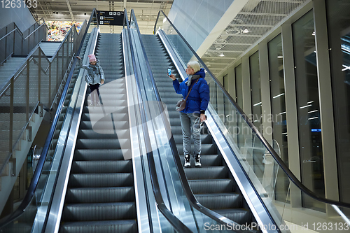 Image of Mother and child together on escalator background. Terminal, air