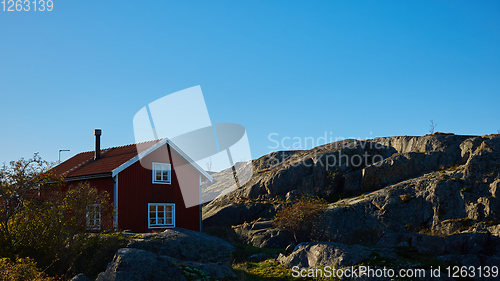 Image of Red house at sea shore in the baltic sea in dull colors in autumn.