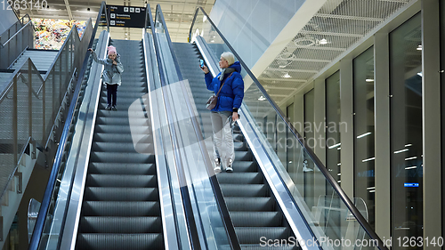 Image of Mother and child together on escalator background. Terminal, air