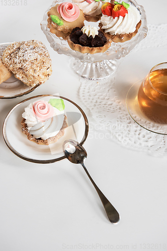 Image of Cakes with tea on white