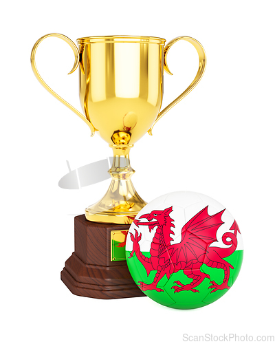 Image of Gold trophy cup and soccer football ball with Wales flag