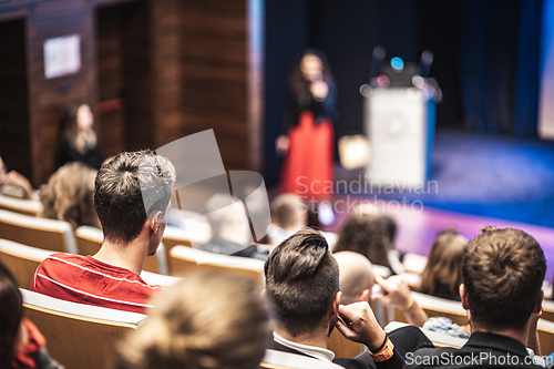 Image of Woman giving presentation on business conference event.