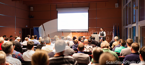 Image of Business speaker giving a talk at business conference meeting event.