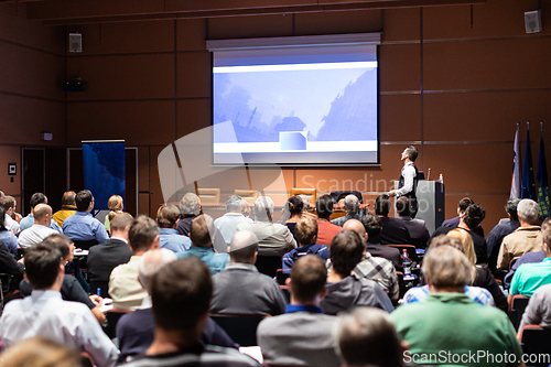 Image of Business speaker giving a talk at business conference meeting event.