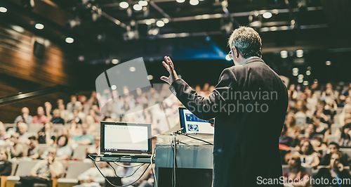 Image of Public speaker giving talk at Business Event.