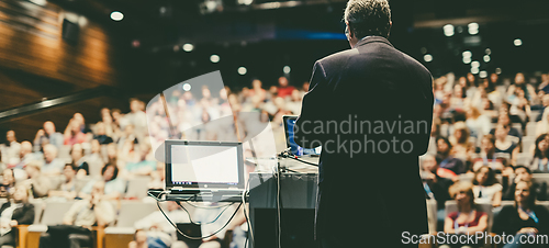 Image of Public speaker giving talk at Business Event.