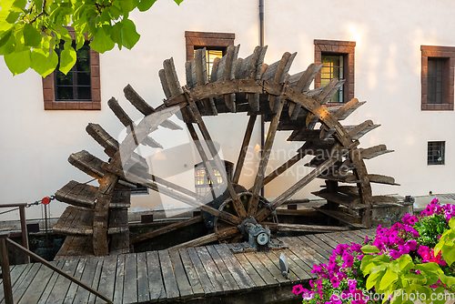 Image of Wooden mill and flower