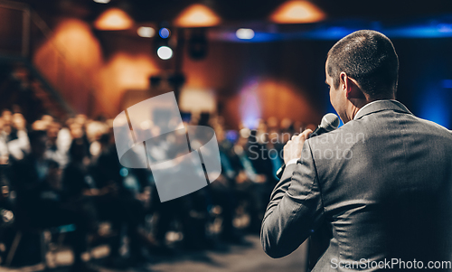 Image of Public speaker giving talk at Business Event.