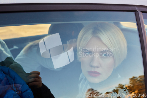 Image of Family concept. Portrait of mother and daughter through the glass of a car