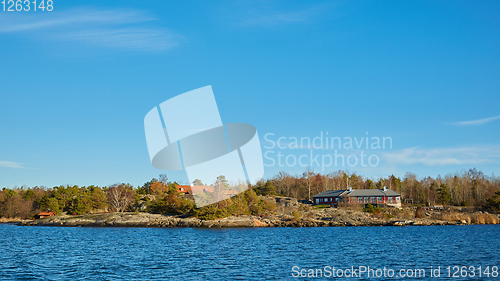 Image of Red house at sea shore in the baltic sea in dull colors in autumn.