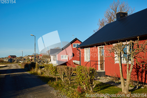 Image of Red house at sea shore in the baltic sea in dull colors in autumn.