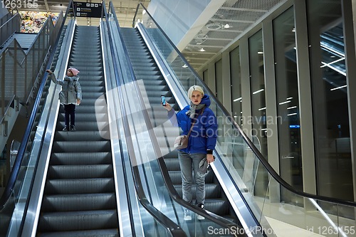 Image of Mother and child together on escalator background. Terminal, air