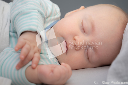 Image of Baby boy sleeping in his bed