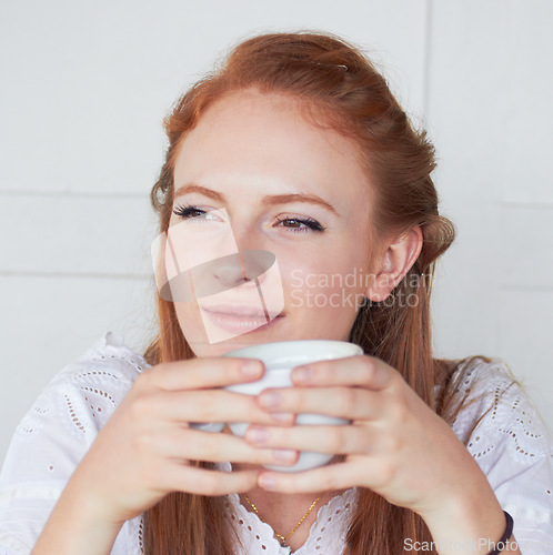Image of Thinking, calm and woman with a cup of coffee in a studio for relax in the morning on a weekend. Dreaming, memory and face of a female model drinking cappuccino, caffeine or latte by white background