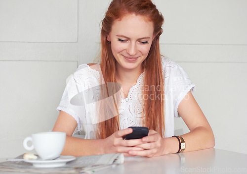 Image of Coffee shop, phone and happy woman texting, relax and smile for chat app on wall background. Cafe, social media and female customer reading post, news or update while enjoying day off and tea break