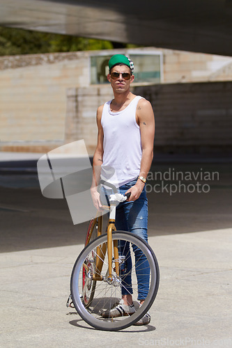 Image of Street wear, fashion and man with a bicycle in a city for eco friendly or sustainable transport on urban background. Style, attitude and male person posing with a bike for cycling, commute or travel