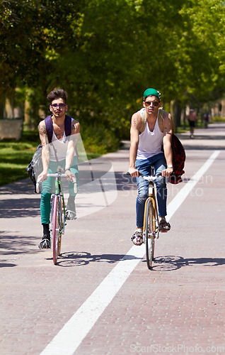 Image of Bicycle, travel and men friends in a city street riding, bond and enjoying freedom on holiday or vacation together. Cycling, bike and people in a road with freedom, adventure and neighborhood hangout