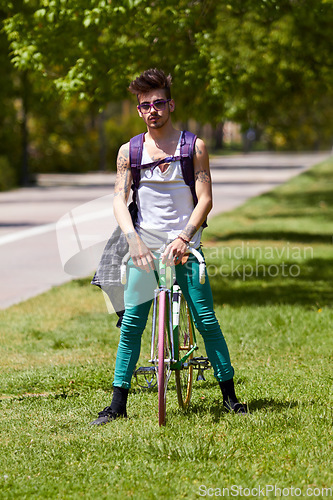 Image of Fashion, street wear and man with a bicycle in a city for eco friendly or sustainable transport on urban background. Style, attitude and male person posing with a bike for cycling, commute or travel