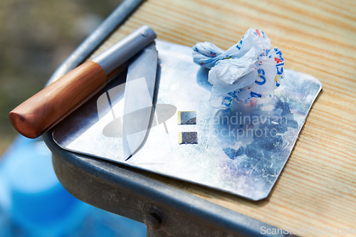 Image of Drugs, closeup and lsd strips on table for psychedelic, trippy and addiction outdoors in park. Danger, narcotics and equipment for habit, gateway and substance abuse or unhealthy micro dosing