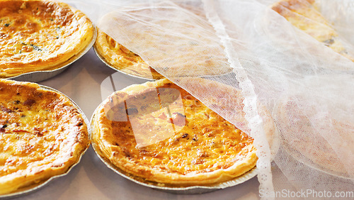 Image of Bakery, quiche and bread pastry in a store with coffee shop food and product in a kitchen. Savory pie, closeup and diner with cloth and vegetable dessert in a cafe with flour and crust for a snack