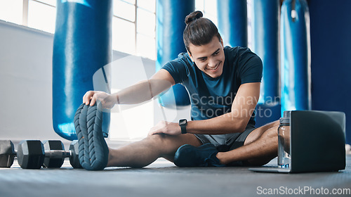 Image of Stretching, fitness and a man with a laptop for exercise tutorial, information or a cardio video. Happy, gym and a male athlete with an online warm up on a computer before training and a workout