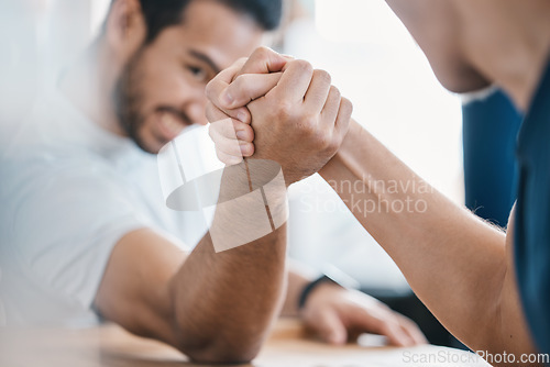 Image of Strong, hands and closeup of men arm wrestling on a table while being playful for a challenge. Rivalry, game and zoom of male people doing a strength muscle battle for fun, bonding and friendship.
