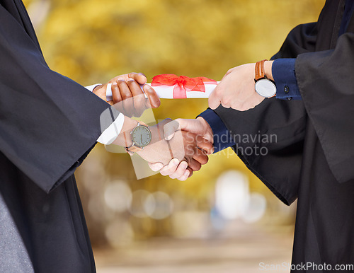 Image of Graduation diploma, handshake and student in success, achievement and congratulations or thank you. Graduate or diversity people shaking hands of certificate, excellence or giving award at university
