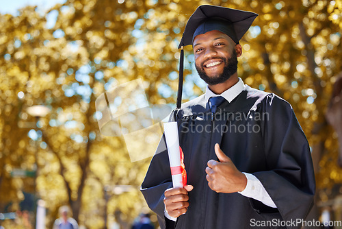 Image of Graduation portrait, thumbs up and man or student on university, education or college campus in diploma success. African person or graduate like, yes and excellence sign, certificate or award in park