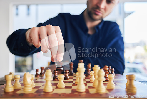 Image of Chess, man moving a piece and game of strategy, problem solving or person playing on chessboard in competition. Planning, choice and hand on knight or king, queen and player thinking of winning move