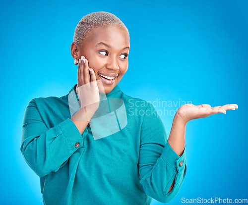 Image of Decision, smile and black woman showing, presentation and promotion against a blue studio background. Sales, female person or model with discount deal, excited and choice with advertising and options