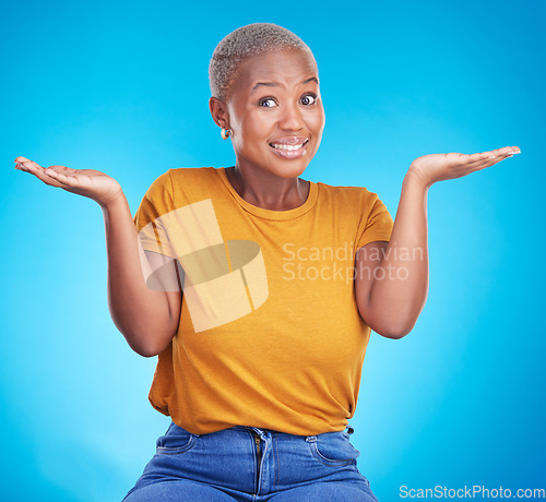 Image of Black woman, shrug and confused portrait in studio with hand gesture, emoji or sign for doubt. African female model on a blue background for choice, decision or questions and why or unsure reaction