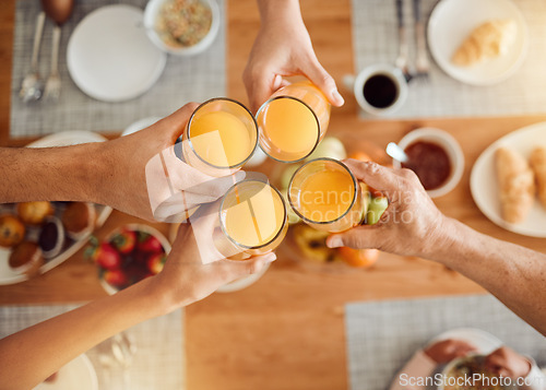 Image of Brunch, hands or people toast with orange juice, beverage or glass drink at lunch, breakfast or food meal. Fruit liquid, top view group or home friends celebrate, support or toasting at reunion event