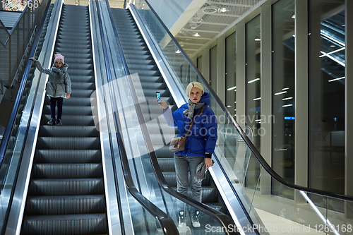 Image of Mother and child together on escalator background. Terminal, air